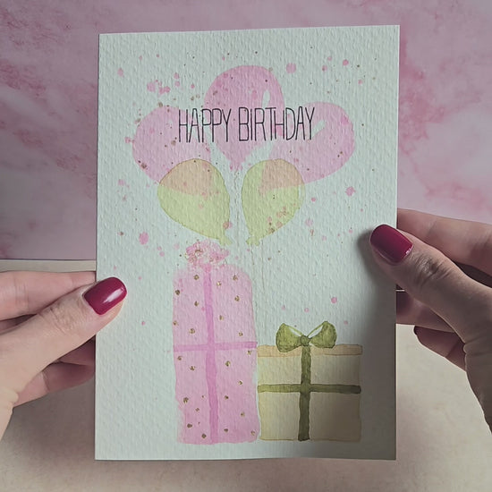 Produktvideo Geburstagskarte mit Motiv aus Luftballons und Geschenken, rosa goldene Geburtstagskarte, handgemalte Karte zum Geburstag